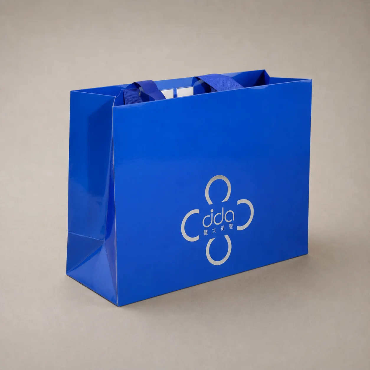 Luxury Royal Sapphire Blue High-Gloss Tote Bag with Silver Clover Emblem — image 1 of 4
