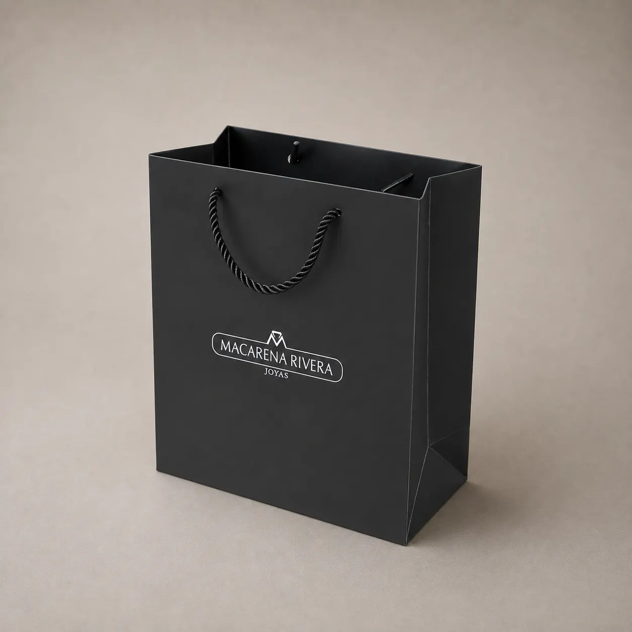 Luxury Pitch Black Paper Tote Bag with Silver Foil Badge — image 1 of 4